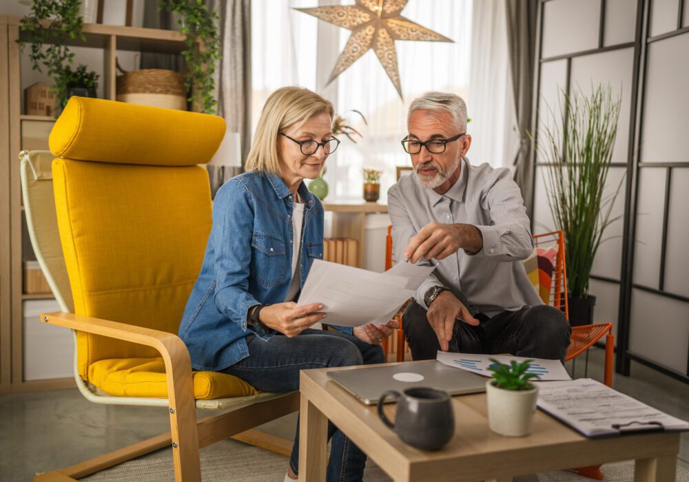 Couple reviewing mortgage note documents together at home