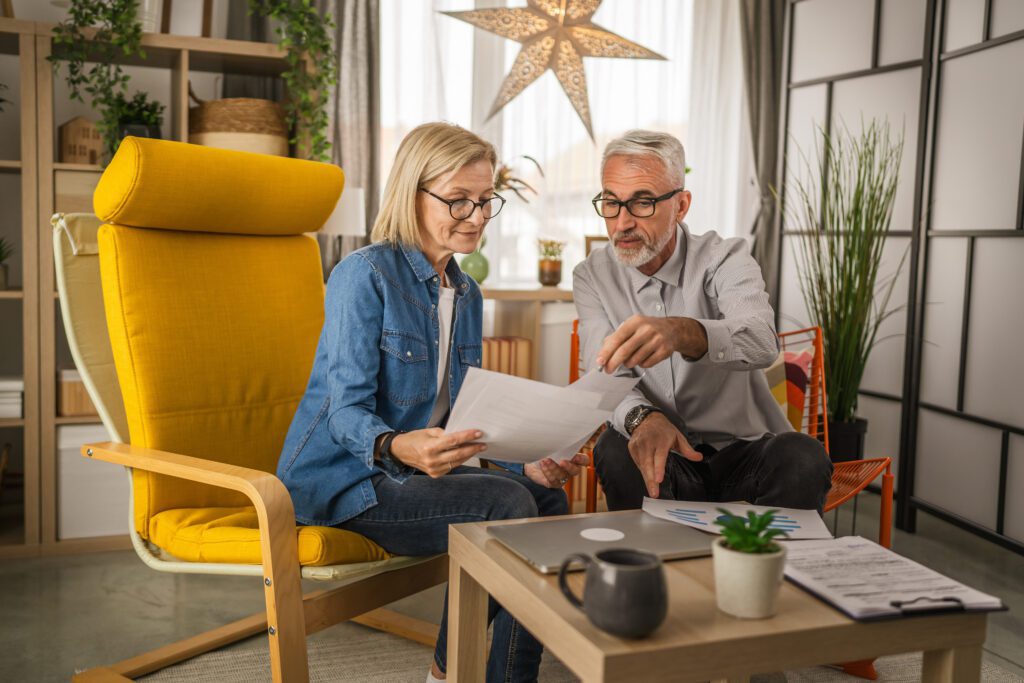 Couple reviewing mortgage note documents together at home