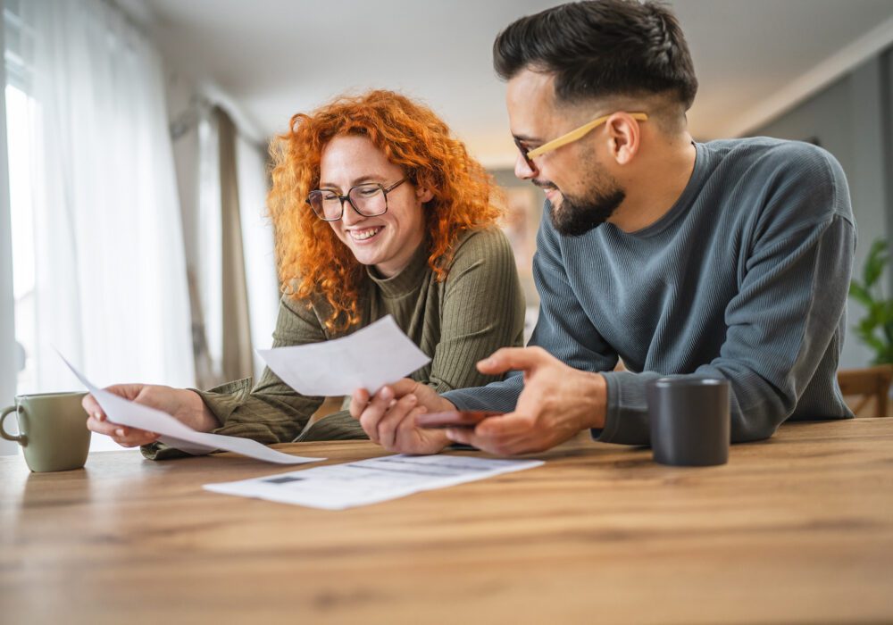 couple at home reviewing documents to protect a seller financed note