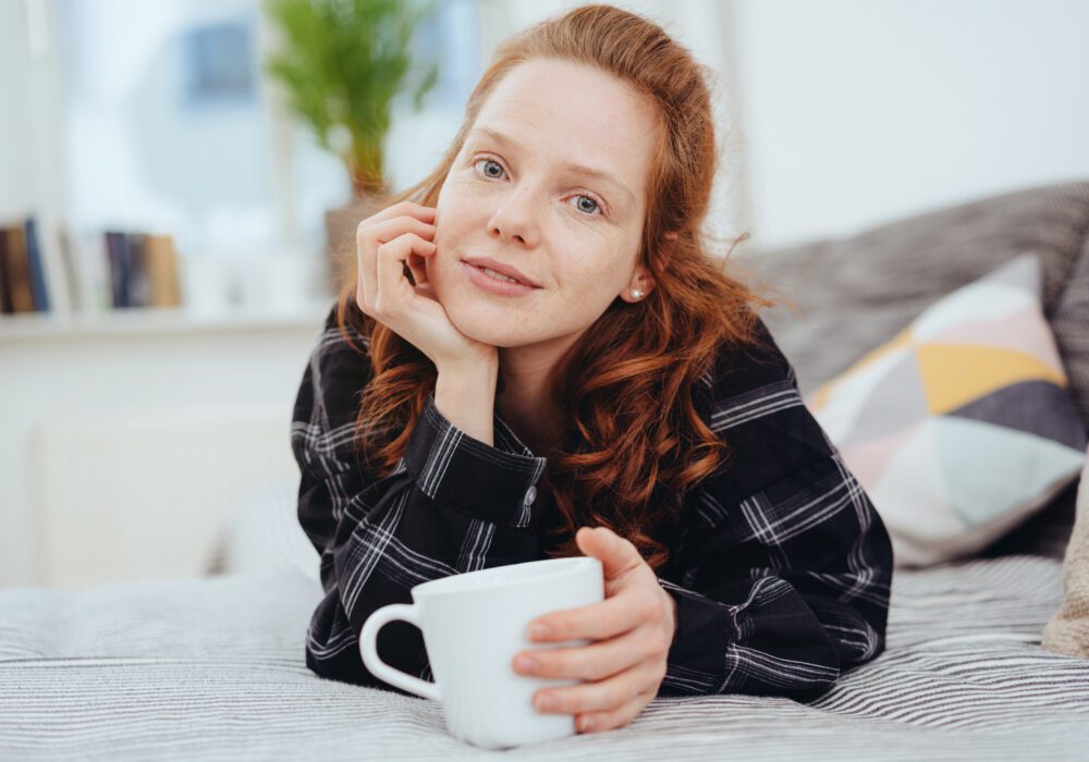 Woman relaxing at home – reassured after working with promissory note buyers.
