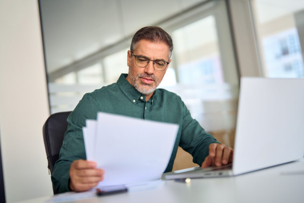 seller financing for landlords – landlord reviewing documents in a softening rent market