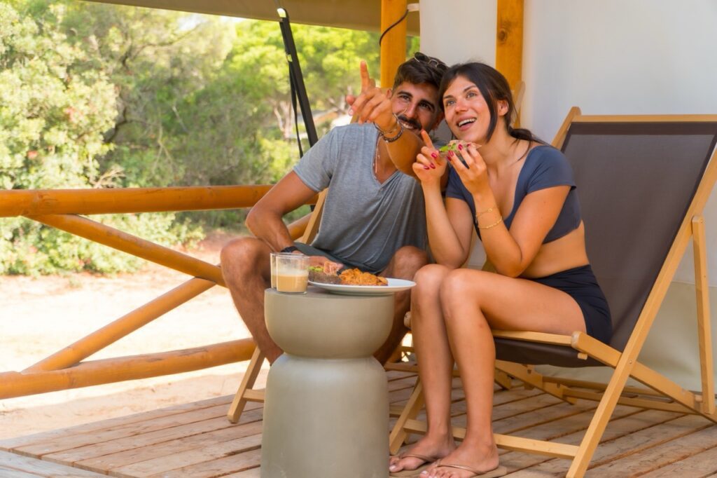 couple relaxing outdoors on a deck exploring options for selling an owner-financed note in 2026